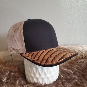 Ball cap with hand-sewn leather patch on brim